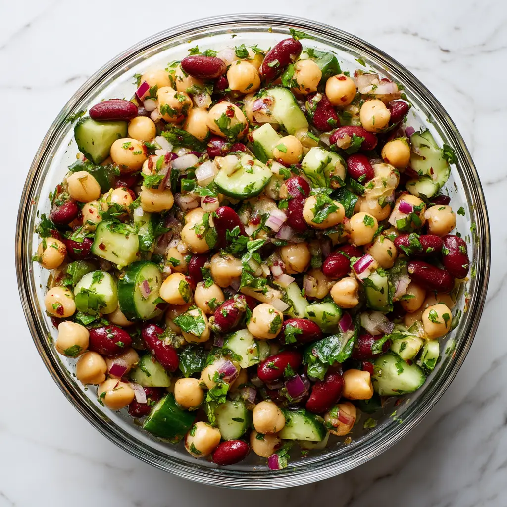 A close-up shot of the finished protein-packed salad in a ceramic bowl, showing the texture of the quinoa and fresh vegetables.