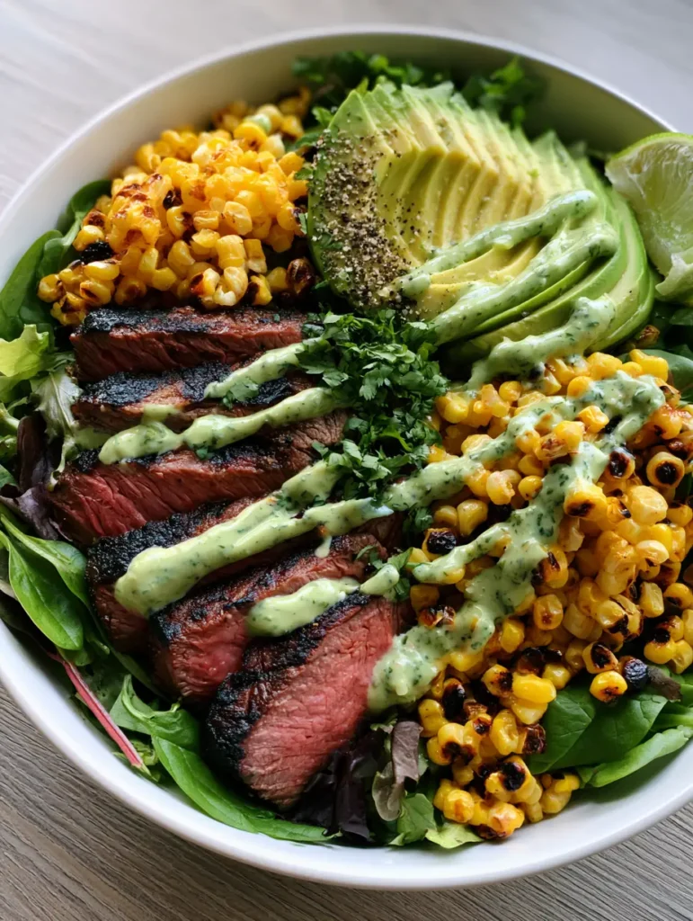 A handheld smartphone photo of a Whole30 Steak and Avocado Bowl showing thick steak slices and a messy zigzag of cilantro sauce.