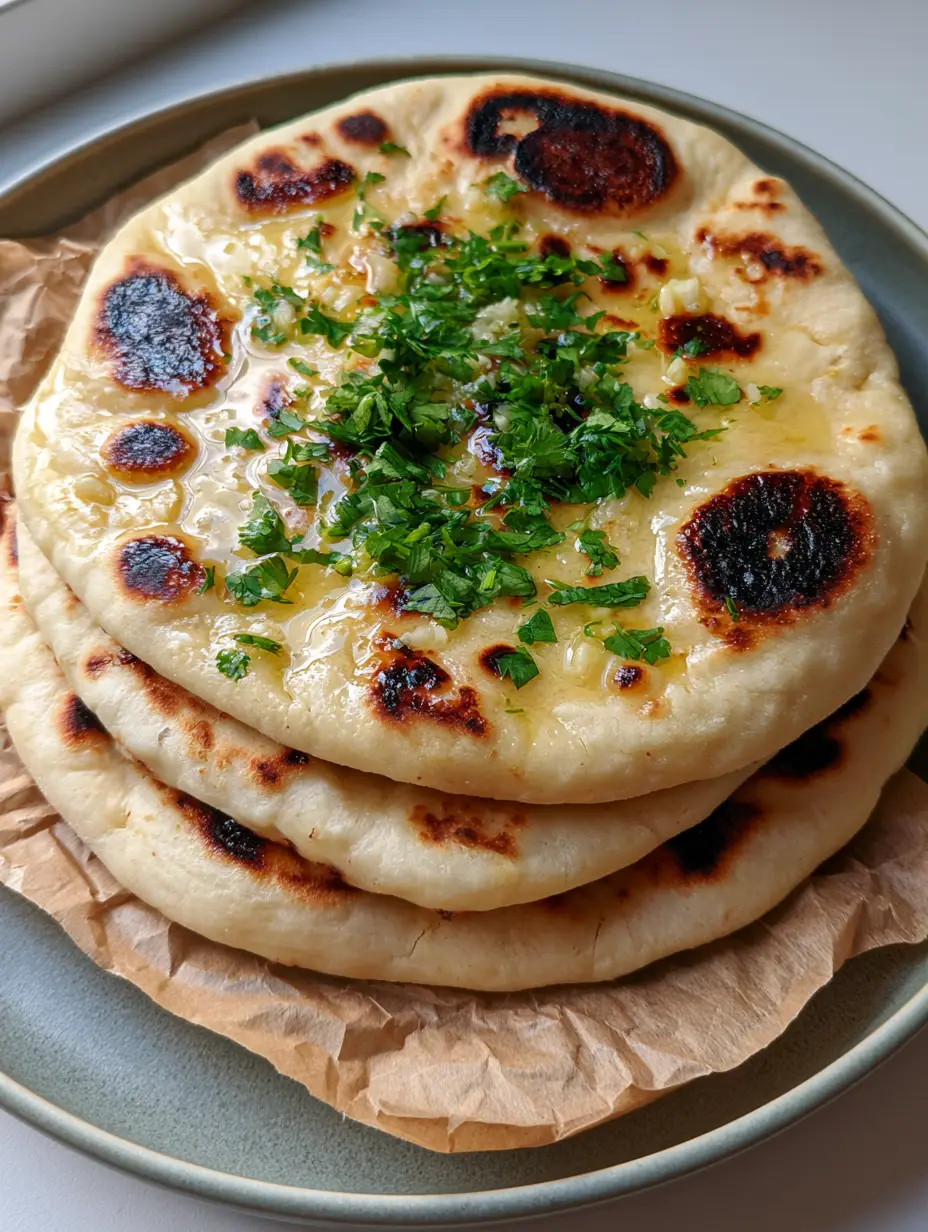 Vegan Gluten-Free Naan: The Ultimate Soft and Garlic-Buttery Flatbread 3 Top-down view of Vegan Gluten-Free Naan with black char marks and glistening butter sheen. (Vegan Gluten-Free Naan)