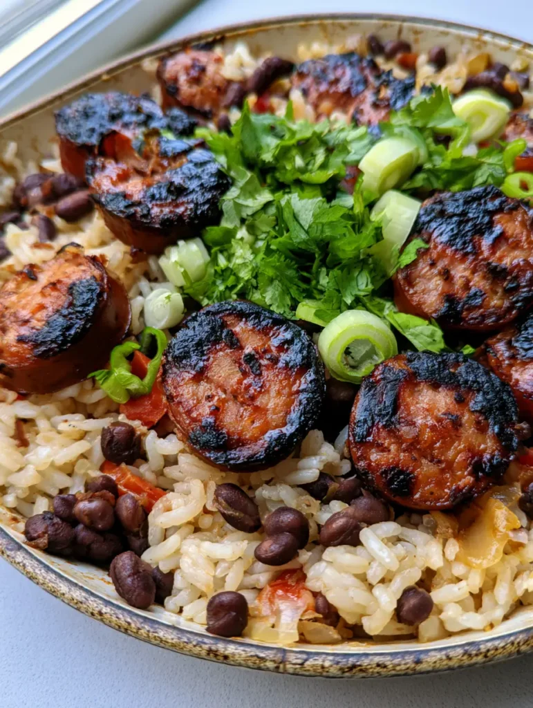 One-Pot Black Beans and Rice with Sausage: The Ultimate 30-Minute Skillet Dinner 1 Close up of fluffy rice, intact black beans, and charred sausage rounds in a One-Pot Black Beans and Rice with Sausage recipe.